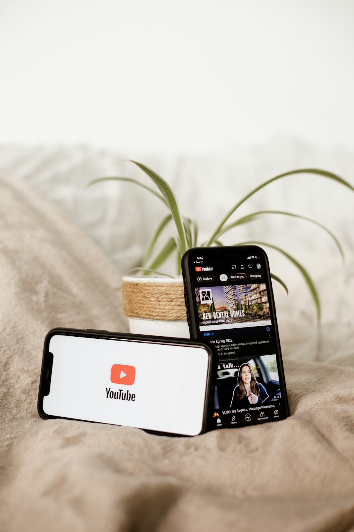 Smartphones displaying YouTube and video influencer content representing the growth of creator marketing campaigns in Saudi Arabia 2026