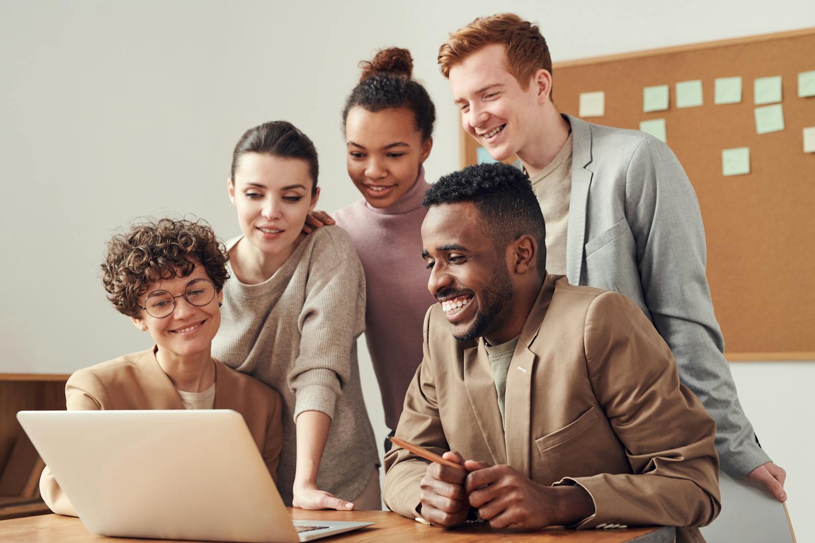 Marketing team reviewing AI-powered influencer campaign results on laptop showing creator match scores brand fit analysis and predictive ROI forecasts for global influencer marketing strategy 2026
